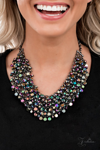 Zi Collection Necklace 2021 - Vivacious - Paparazzi Fiercely faceted oil spill beads flawlessly cascade from row after row of boldly interlocking gunmetal links that connect into an intense metallic netted backdrop. Attached to matching chunky gunmetal chains, the effervescently edgy display noisily swishes back and forth, creating an out-of-this-world fringe below the collar. Features an adjustable clasp closure.  Sold as one individual necklace. Includes one pair of matching earrings.
