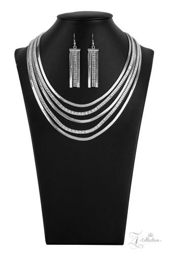 Zi Collection Necklace 2021 - Persuasive - Paparazzi Alternating rows of flat silver snake chain and glassy strands of edgy emerald cut rhinestones sleekly layer below the collar. The deceptively simple metallic silver and white rhinestone palette is unapologetically mesmerizing, making this smooth statement piece an instant classic. Features an adjustable clasp closure.  Sold as one individual necklace. Includes one pair of matching earrings.