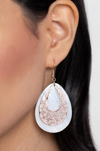 A hammered rose gold teardrop that is stenciled in an abstract pattern delicately overlaps with a white shell-like teardrop, creating a whimsical lure as it swings from the ear. Earring attaches to a standard fishhook fitting.  Sold as one pair of earrings.