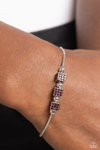Dainty silver beads and purple rhinestone encrusted silver cubes slide along a rounded silver snake chain around the wrist, resulting in a radiant centerpiece. Features an adjustable sliding bead closure.  Sold as one individual bracelet.