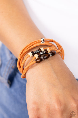 An earthy assortment of silver beads, textured silver accents, and brown and white wooden beads glides along layered strands of rustic orange suede, resulting in a whimsically layered centerpiece. Features an adjustable sliding knot closure.  Sold as one individual bracelet.