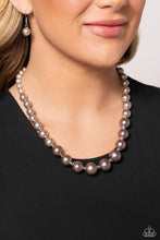 Load image into Gallery viewer, A single strand of white, silver, and dark gray pearls elegantly cascades below the collar, creating a glamorous ombre effect. Features an adjustable clasp closure.  Sold as one individual necklace. Includes one pair of matching earrings.
