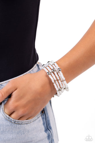 Pearly white seed beads, and various-sized silver accents are threaded along a coiled wire, creating a refined infinity wrap-style bracelet around the wrist.   Featured inside The Preview at Made for More! Sold as one individual bracelet