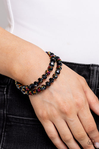 Featuring a UV shimmer, a glistening collection of faceted metallic black beads alternate with dainty oil spill studs along a coiled wire, creating a jaw-dropping infinity wrap bracelet around the wrist. Due to its prismatic palette, color may vary.  Sold as one individual bracelet.