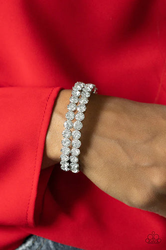 Encased in sleek silver fittings, two oversized rows of glassy white rhinestones stack into a blinding cuff around the wrist for a jaw-dropping look.  Sold as one individual bracelet.