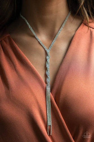 Silvery ribbons of glassy white rhinestones loop around the neck and delicately twist into an icy tassel down the chest. Features an adjustable clasp closure.  Sold as one individual necklace. Includes one pair of matching earrings.