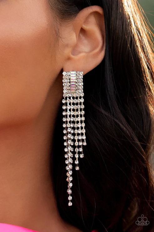 A tapered fringe of glittery white rhinestones streams out from the bottom of a rectangular silver frame. Dotted in rows of blinding white rhinestones, the center of the glitzy fitting is infused with a raised row of emerald-cut iridescent rhinestones for a dramatic dazzle. Due to its prismatic palette, color may vary. The earring attaches to a standard post-fitting.  Sold as one pair of post earrings.