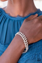 Load image into Gallery viewer, Set in pronged silver settings, pairs of icy white rhinestones haphazardly stack around the wrist in sizzling rows of shimmer. Features an adjustable clasp closure.  Sold as one individual bracelet.
