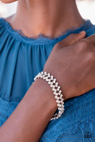 Set in pronged silver settings, pairs of icy white rhinestones haphazardly stack around the wrist in sizzling rows of shimmer. Features an adjustable clasp closure.  Sold as one individual bracelet.