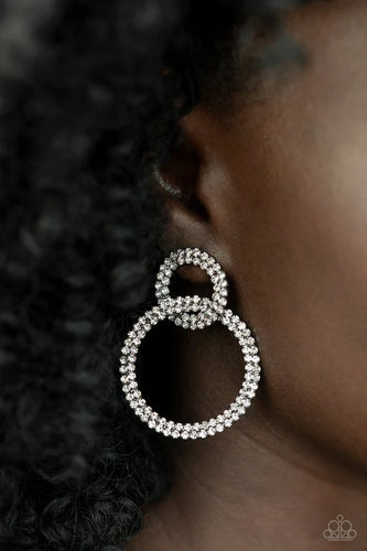 Rows of sparkly white rhinestones encircle two interconnected hoops, creating a jaw-dropping lure. Earring attaches to a standard post-fitting.  Sold as one pair of post earrings.