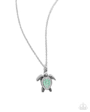 Load image into Gallery viewer, Swimming along a dainty silver chain, an oversized silver turtle pendant with a Grass Green pearl-painted and white rhinestone embellished shell and eyes shimmers below the neckline for a classic, coastal look. Features an adjustable clasp closure.
