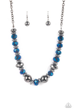 Load image into Gallery viewer, A dramatic assortment of oversized gunmetal beads, textured gunmetal rings, and faceted metallic blue gems delicately glides along an invisible wire below the collar, resulting in a stellar sparkle. Features an adjustable clasp closure.  Sold as one individual necklace. Includes one pair of matching earrings.
