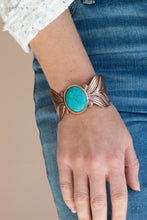 Load image into Gallery viewer, Etched and embossed in lifelike textures, two oversized copper feathers branch out from a refreshing turquoise stone center, curling into a whimsical cuff around the wrist.  Sold as one individual bracelet.
