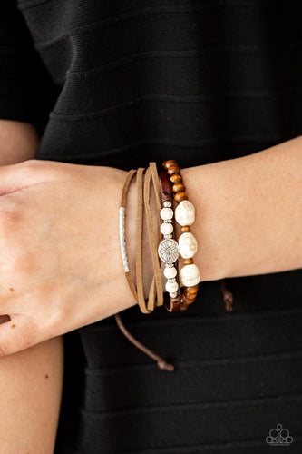 Featuring natural white stone and silver accents, a collection of leather strands and wooden beads encircle the wrist in a subtle Southwestern fashion. Features an adjustable sliding knot closure.  Sold as one individual bracelet.