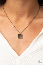 Load image into Gallery viewer, A curved brass square engraved with the words &quot;Chaos Coordinator&quot; dangles from a brass chain creating a playful medallion below the collar. Features an adjustable clasp closure.  Sold as one individual necklace. Includes one pair of matching earrings.
