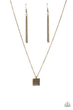 Load image into Gallery viewer, A curved brass square engraved with the words &quot;Chaos Coordinator&quot; dangles from a brass chain creating a playful medallion below the collar. Features an adjustable clasp closure.  Sold as one individual necklace. Includes one pair of matching earrings.

