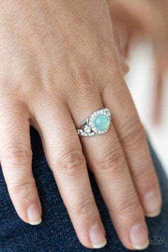 An opal green bead is pressed into the center of a ring of white rhinestones that sits atop interwoven silver bars dotted in dainty white rhinestones, creating an ethereally elegant centerpiece atop the finger. Features a dainty stretchy band for a flexible fit.  Sold as one individual ring.