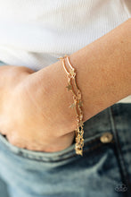 Load image into Gallery viewer, A collection of dainty gold stars and curved gold bars delicately connect around the wrist, creating a stellar fringe. Features an adjustable clasp closure.
