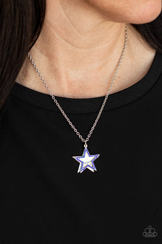 A blue rhinestone encrusted silver star delicately overlaps with a shiny silver star below the collar, creating a sparkly patriotic pendant. Features an adjustable clasp closure.  Sold as one individual necklace. Includes one pair of matching earrings.
