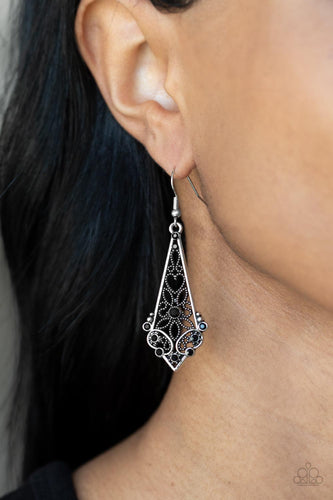 Dotted heart and flower filigree motifs permeate an elongated diamond-shaped silver frame. Dainty black rhinestones scatter across the design creating a whimsical lure. Earring attaches to a standard fishhook fitting.  Sold as one pair of earrings.