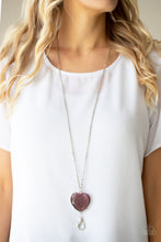 Load image into Gallery viewer, An oversized purple cat&#39;s eye stone frame swings from the bottom of a lengthened silver chain, creating a flirtatious pendant. A lobster clasp hangs from the bottom of the design to allow a name badge or other item to be attached. Features an adjustable clasp closure.  Sold as one individual lanyard. Includes one pair of matching earrings.
