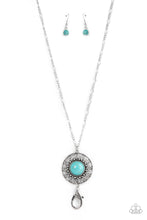 Load image into Gallery viewer, An oversized turquoise stone adorns the center of an antiqued silver frame radiating with silver studded and wire-like detail, creating an authentic artisan inspired pendant. A lobster clasp hangs from the bottom of the design to allow a name badge or other item to be attached. Features an adjustable clasp closure.  Sold as one individual lanyard. Includes one pair of matching earrings.

