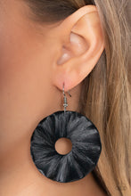 Load image into Gallery viewer, Shiny black crepe-like paper is wrapped around a rippling round disc, creating a modern display. Earring attaches to a standard fishhook fitting.
