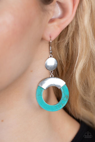 Capped in a curved silver plate, a refreshing turquoise stone hoop swings from the bottom of a shiny silver disc for an authentic artisan twist. Earring attaches to a standard fishhook fitting.  Sold as one pair of earrings.