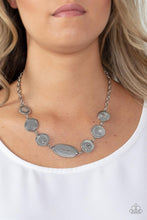 Load image into Gallery viewer, Sporadically dotted in dainty hematite rhinestones and metallic rope-like texture, an asymmetrical assortment of shiny silver frames delicately link below the collar for a one-of-a-kind shimmer. Features an adjustable clasp closure.  Sold as one individual necklace. Includes one pair of matching earrings.
