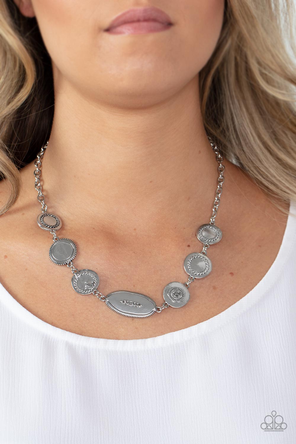 Sporadically dotted in dainty hematite rhinestones and metallic rope-like texture, an asymmetrical assortment of shiny silver frames delicately link below the collar for a one-of-a-kind shimmer. Features an adjustable clasp closure.  Sold as one individual necklace. Includes one pair of matching earrings.