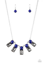 Load image into Gallery viewer, A sparkly row of oversized blue gems regally sit atop emerald cut smoky rhinestone bases as they delicately link along a dainty silver chain below the collar, resulting in a royal glamorous centerpiece. Features an adjustable clasp closure.  Sold as one individual necklace. Includes one pair of matching earrings.
