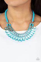 Load image into Gallery viewer, Varying in size, a glassy collection of blue teardrops alternate with dainty silver beads in two rows below the collar for a glamorous pop of color. Features an adjustable clasp closure.  Sold as one individual necklace. Includes one pair of matching earrings.
