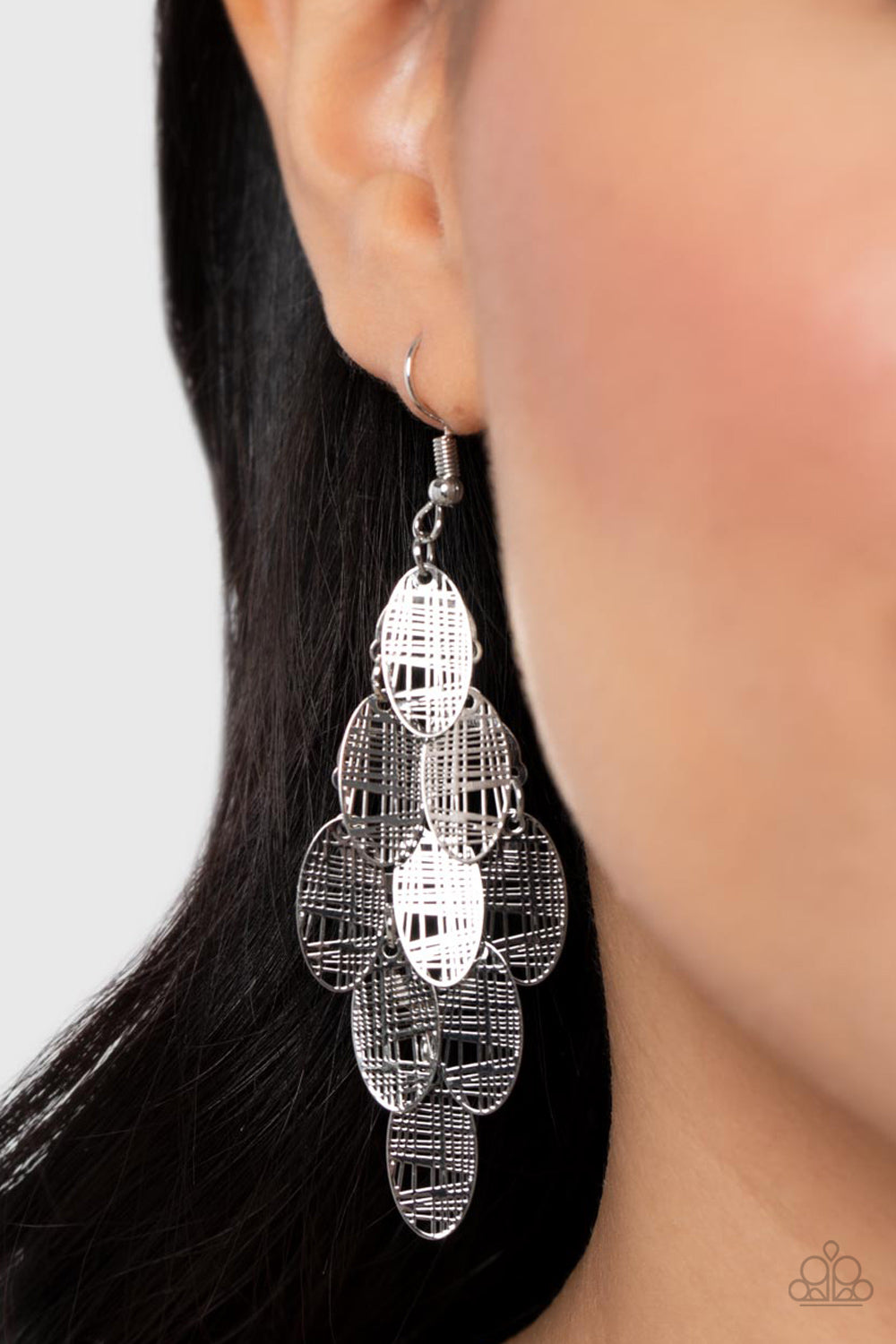Featuring abstract crisscrossed texture, oval silver frames cascade from a metallic netted backdrop, resulting in a noise-making lure. Earring attaches to a standard fishhook fitting.  Sold as one pair of earrings.