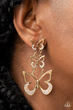 Load image into Gallery viewer, An airy trio of gold butterflies gradually increase in size as they link into a whimsical lure. The bottom of each butterfly has been dipped in iridescent rhinestones, adding a glitzy finish to the fluttering centerpiece. Earring attaches to a standard fishhook fitting.  Sold as one pair of post earrings.
