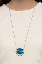 Load image into Gallery viewer, A pair of blue acrylic half moon frames are separated by a shiny silver bar at the bottom of a crescent shaped silver frame, resulting in an ethereal pendant at the bottom of an extended silver chain. Due to the nature of the materials, colors may vary. Features an adjustable clasp closure.  Sold as one individual necklace. Includes one pair of matching earrings.
