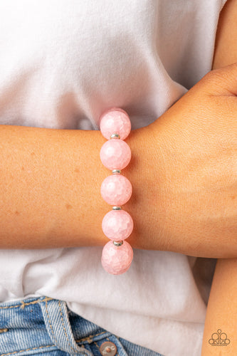 Infused with dainty silver accents, an oversized collection of crackly pink glass-like beads are threaded along stretchy bands around the wrist for an icy look.  Sold as one individual bracelet.