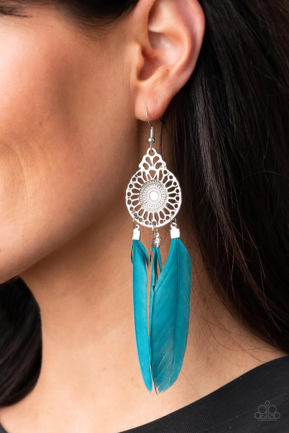 Three Mykonos Blue feathers swing from the bottom of a dizzying silver frame featuring airy filigree detail, resulting in a flirtatiously colorful fringe. Earring attaches to a standard fishhook fitting.  Sold as one pair of earrings.
