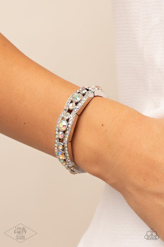 Iridescent rhinestone encrusted silver bars flank a dazzling trio of oversized iridescent rhinestones, coalescing into a glittery frame. The sparkly frames are threaded along stretchy bands around the wrist, creating an irresistible shimmer.  Sold as one individual bracelet.