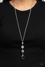 Load image into Gallery viewer, A white rhinestone encrusted silver frame is flanked between two silver discs scratched in a glistening shimmer as they drip from an ornately double-linked silver chain down the chest. A lobster clasp hangs from the bottom of the design to allow a name badge or other item to be attached. Features an adjustable clasp closure.  Sold as one individual lanyard. Includes one pair of matching earrings.

