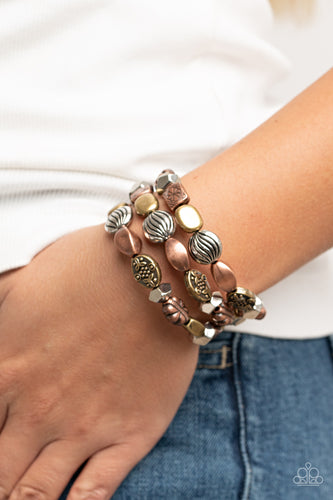 An enchanting assortment of faceted and floral embossed copper, brass, and silver beads alternates along a coiled wire, creating a whimsical infinity style bracelet around the wrist.  Sold as one individual bracelet.