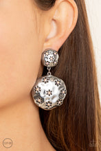 Load image into Gallery viewer, Dotted with dainty iridescent pink rhinestone centers, an antiqued floral pattern is stamped across the fronts of two hammered silver discs that delicately connect into a rustic lure. Earring attaches to a standard clip-on fitting.
