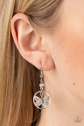 Dotted with glassy white rhinestones, a dainty silver butterfly flutters inside of a textured silver hoop at the bottom of a solitaire white rhinestone for an enchanting fashion. Earring attaches to a standard fishhook fitting.  Sold as one pair of earrings.