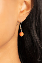 Load image into Gallery viewer, A mismatched collection of textured and smooth silver links gives way to an oversized orange stone hoop at the bottom of an extended silver chain, resulting in an earthy centerpiece. Features an adjustable clasp closure.  Sold as one individual necklace. Includes one pair of matching earrings.
