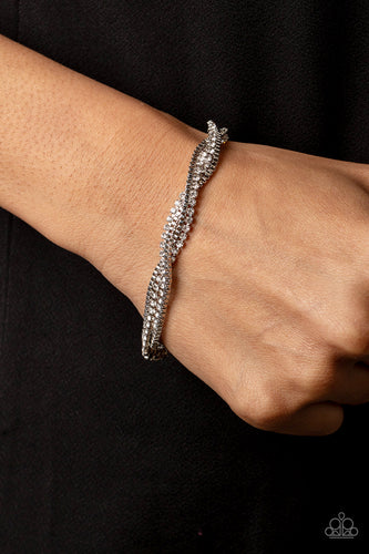 Glittery strands of dainty white rhinestones and shiny silver box chain weave around the wrist, resulting in an irresistible sparkle. Features an adjustable clasp closure.  Sold as one individual bracelet.