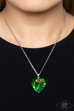 Load image into Gallery viewer, Chiseled into a charming heart, an oversized multicolored gem with a refracted shimmer slides along a dainty silver chain below the collar for a flirtatious finish. Features an adjustable clasp closure. Due to its prismatic palette, color may vary.  Sold as one individual necklace. Includes one pair of matching earrings.
