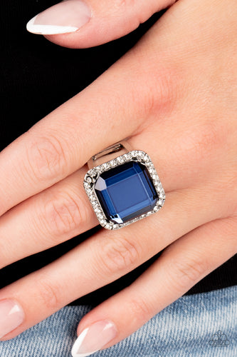 A lavish square Skydiver gem, encased in a border of dainty white rhinestones, makes a head-turning centerpiece as it gleams with an industrial edge atop the finger. Features a stretchy band for a flexible fit.  Sold as one individual ring.