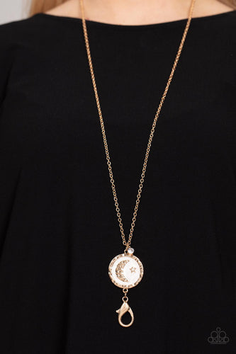 Painted in a milky pearlized lacquer finish, an asymmetrical gold disc is dotted with a dainty gold moon and star accent as it swings from the bottom of a lengthened gold chain. Sold as one individual lanyard. Includes one pair of matching earrings.