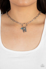 Load image into Gallery viewer, A simple silver hoop is centered between strands of oblong silver chain links. A collection of charms swings from the airy hoop, including a silver bar stamped with the word &quot;Believe&quot;, a silver bird charm, a faceted blue gem, and a dainty iridescent rhinestone. Features an adjustable clasp closure. Due to its prismatic palette, color may vary.  Sold as one individual necklace. Includes one pair of matching earrings.
