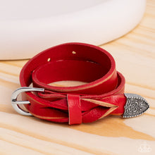Load image into Gallery viewer, Featuring a weathered finish, a red leather band loops around the wrist in a belt loop fashion. Featured at the end of the loop, the leather braids into a silver cap fitting, embossed with a coat of arms style filigree for an urban statement. Features an adjustable belt loop closure.   Featured inside The Preview at Made for More! Sold as one individual bracelet.
