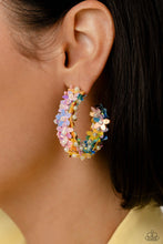 Load image into Gallery viewer, A floral explosion, encompassing the entirety of a thick silver hoop, features reflective light blue, pink, and yellow flowers dotted with dainty pearl centers for a dreamy, whimsicality below the ear. Earring attaches to a standard post fitting. Hoop measures approximately 1 1/2&quot; in diameter.  Sold as one pair of hoop earrings.
